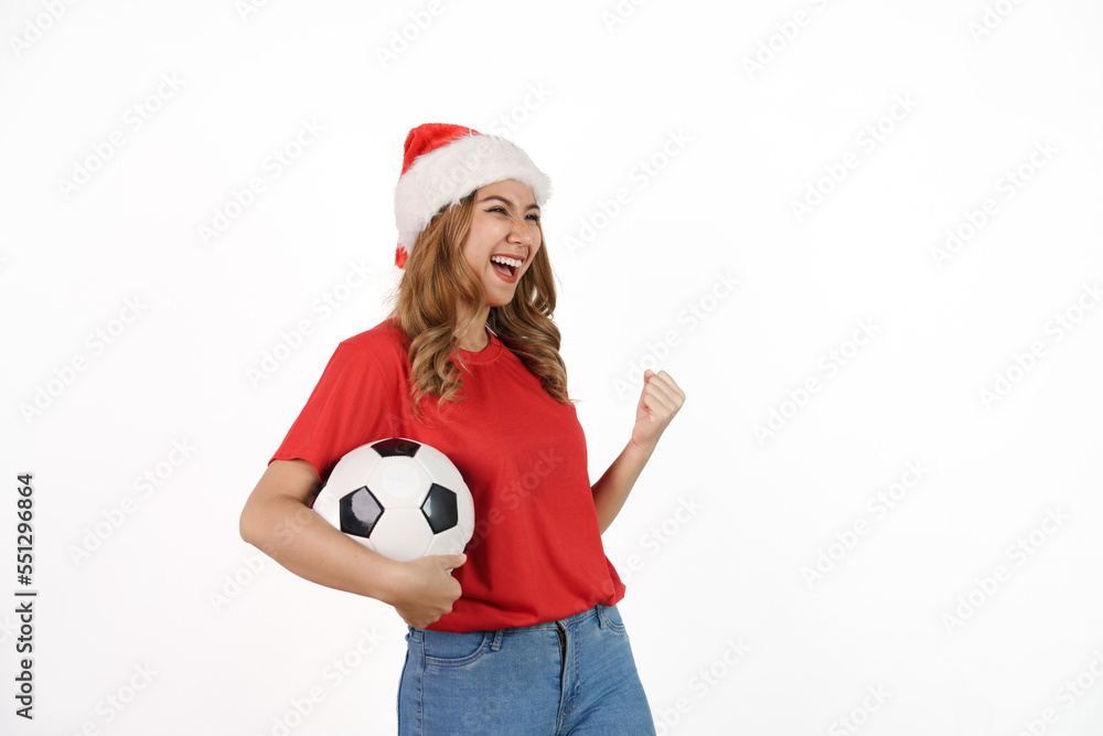Happy asian woman in santa hat and red t-shirt isolated on white background. Celebrate World Cup victory, soccer fans concept. Happy asian woman in santa hat and red t-shirt isolated on white background. Celebrate World Cup victory, soccer fans concept.