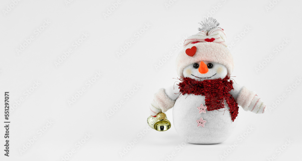 Handmade Cute snowman holding jingle bells on white background Handmade Cute snowman holding jingle bells on white background