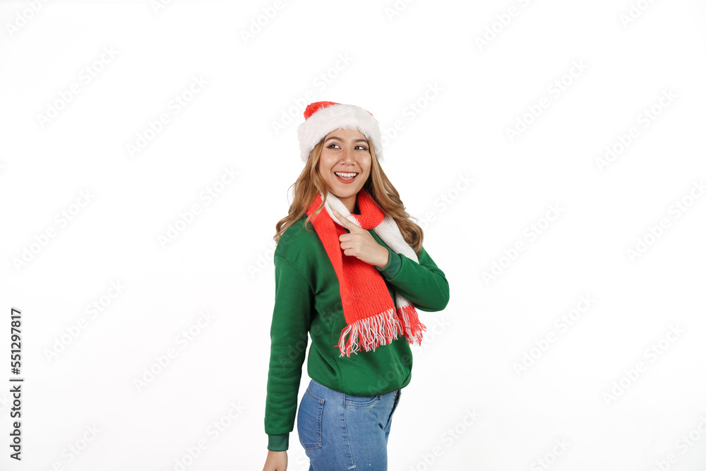 Attractive excited asian female in green sweater with santa hat on christmas isolated on white background. Attractive excited asian female in green sweater with santa hat on christmas isolated on white background.