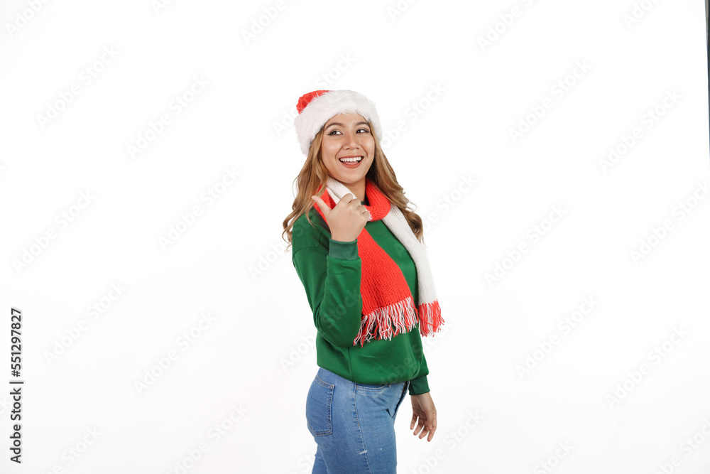 Attractive excited asian female in green sweater with santa hat on christmas isolated on white background. Attractive excited asian female in green sweater with santa hat on christmas isolated on white background.