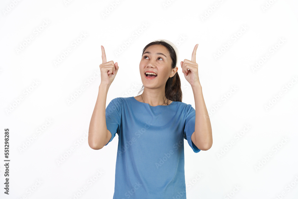 Beautiful Asian woman in blue t-shirt isolated on white background. Pointing Beautiful Asian woman in blue t-shirt isolated on white background. Pointing
