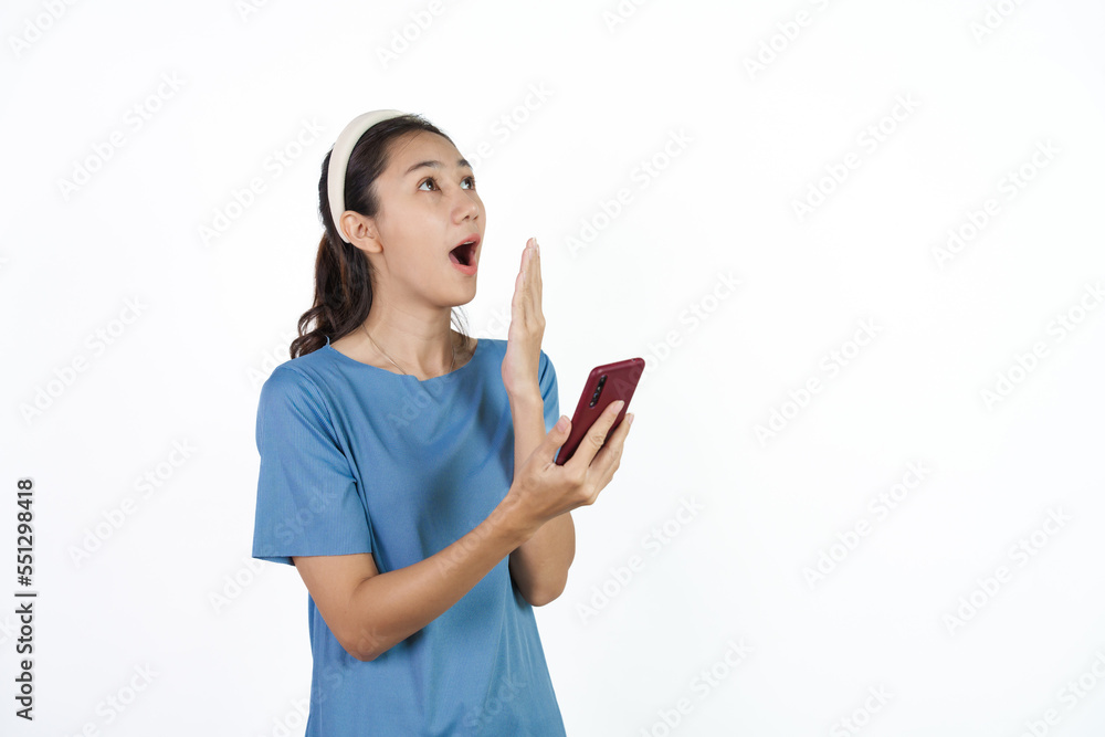 Beautiful Asian woman in blue t-shirt isolated on white background. Holding cellphone