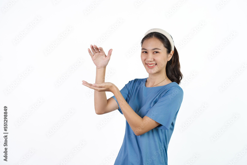 Beautiful Asian woman in blue t-shirt isolated on white background. Holding hands product Beautiful Asian woman in blue t-shirt isolated on white background. Holding hands product