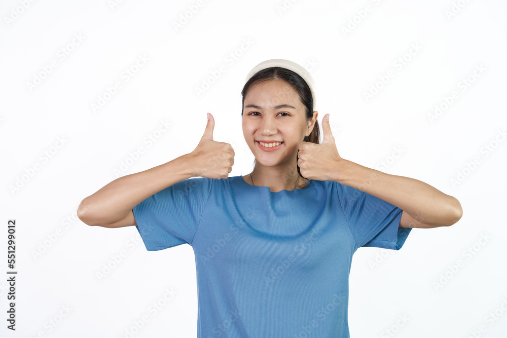 Beautiful Asian woman in blue t-shirt isolated on white background. Thumb up Beautiful Asian woman in blue t-shirt isolated on white background. Thumb up