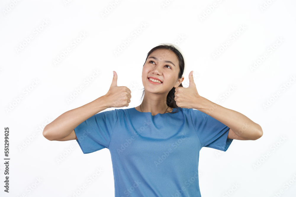 Beautiful Asian woman in blue t-shirt isolated on white background. Thumb up Beautiful Asian woman in blue t-shirt isolated on white background. Thumb up