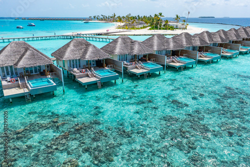 Maldives paradise island. Tropical aerial landscape, seascape water bungalows villas private pools with amazing sea lagoon beach. Exotic tourism destination, summer vacation background. Aerial travel