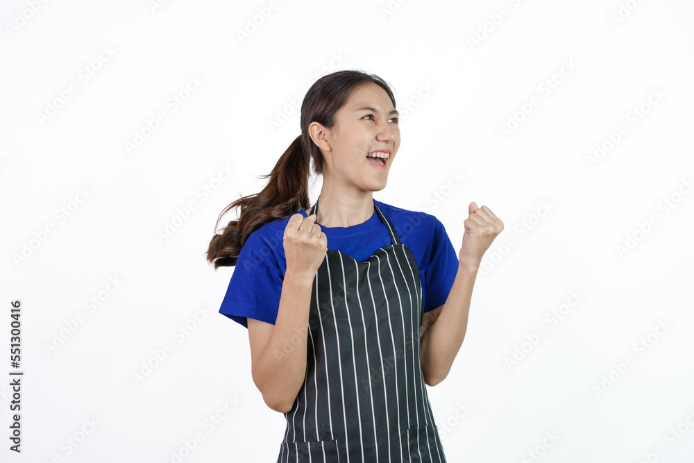 Excited asian coffee shop SME owner asian woman wearing blue t-shirt and black apron isolated on white background. Surprise, win, yes Excited asian coffee shop SME owner asian woman wearing blue t-shirt and black apron isolated on white background. Surprise, win, yes