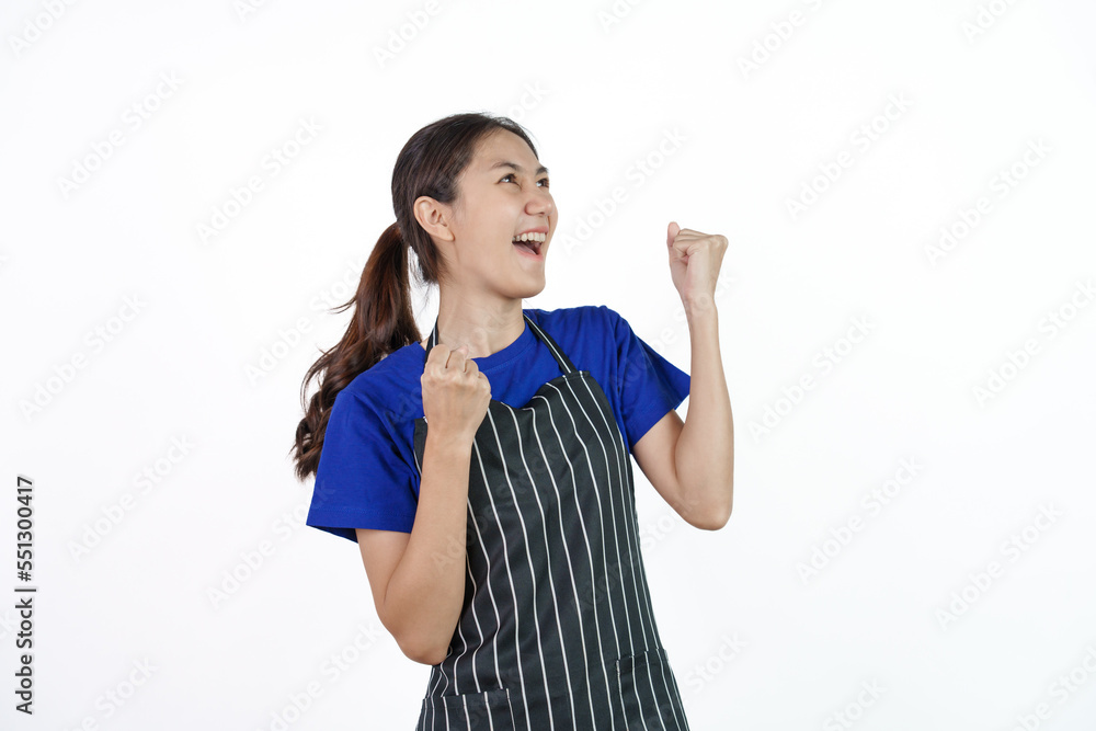 Excited asian coffee shop SME owner asian woman wearing blue t-shirt and black apron isolated on white background. Surprise, win, yes Excited asian coffee shop SME owner asian woman wearing blue t-shirt and black apron isolated on white background. Surprise, win, yes