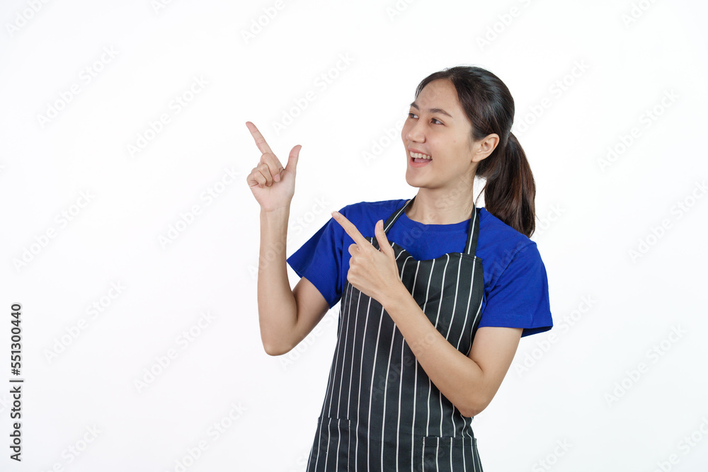 Excited asian coffee shop SME owner asian woman wearing blue t-shirt and black apron isolated on white background. Hands pointing Excited asian coffee shop SME owner asian woman wearing blue t-shirt and black apron isolated on white background. Hands pointing