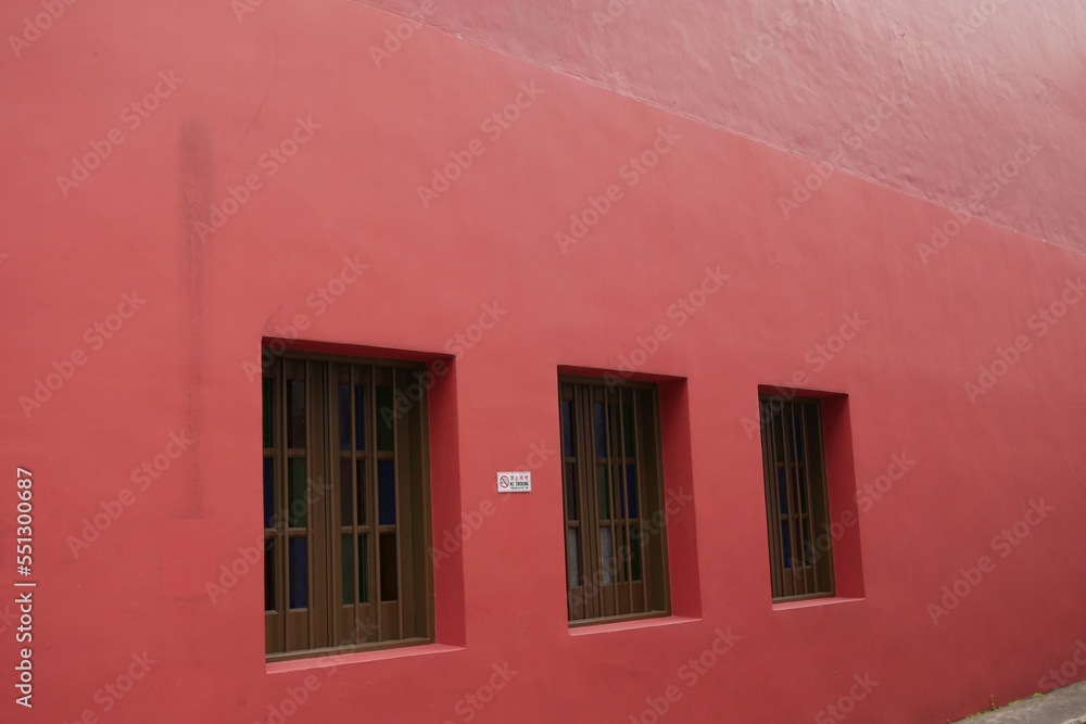  vintage color windows on red wall in a buildings 
