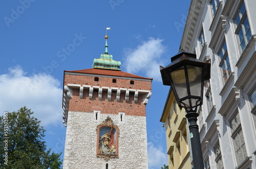 lantern in front of "Florians Gate" under blue sky in Krakow