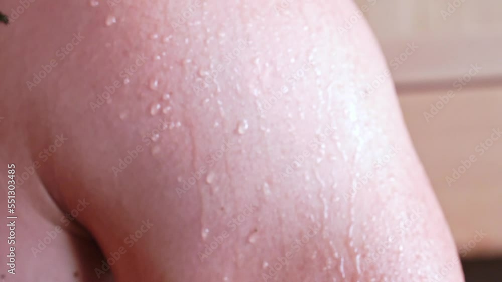 close-up of a drop of water on the body after a shower. Drops of sweat on a man's body after a bath. Close-up of water draining from the body. close-up of a drop of water on the body after a shower. Drops of sweat on a man's body after a bath. Close-up of water draining from the body.