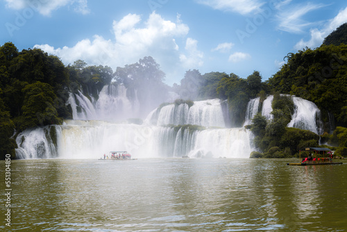 Chongzhuo  China - August 15  2021  Tourist boats by the Detian Ban gioc waterfalls on China and Vietnam border