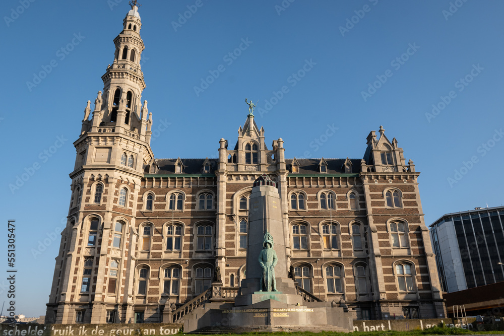 Historic building the old pilot station for Antwerp port is a neo-renaissance palace with statue of Brabo on top and war memorial in front