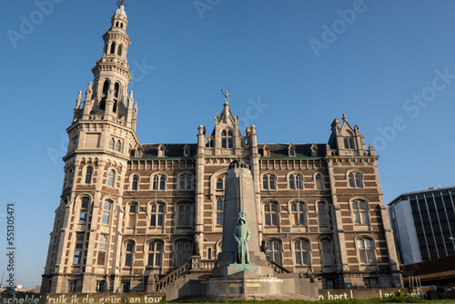 Historic building the old pilot station for Antwerp port is a neo-renaissance palace with statue of Brabo on top and war memorial in front