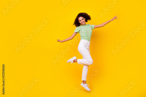 Full size photo of young attractive gorgeous nice pretty woman dancing celebrating jump air pms period isolated on bright yellow color background