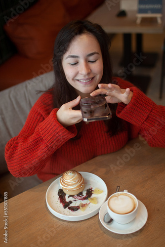 Wallpaper Mural young girl in a cafe shoots food Torontodigital.ca