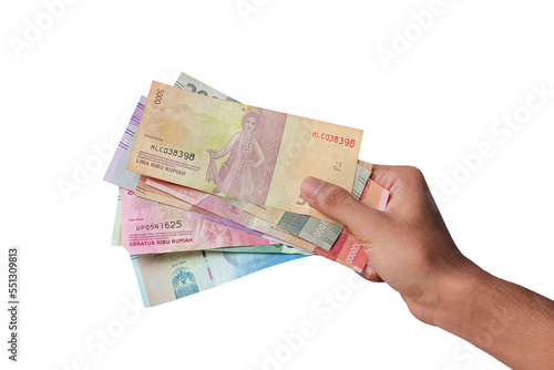 hand holding rupiah money isolated on white background