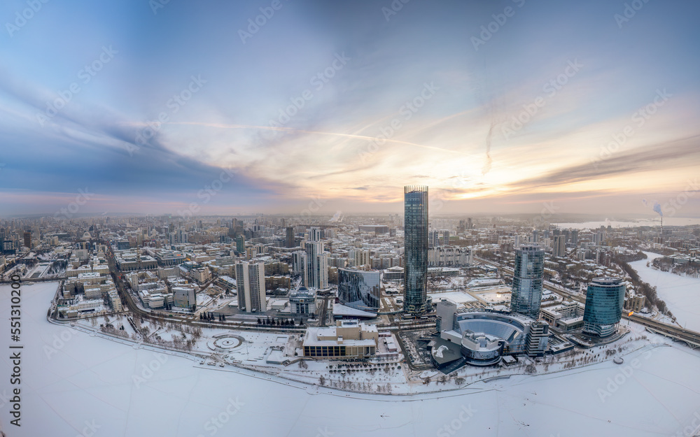Fototapeta premium Yekaterinburg city with Buildings of Regional Government and Parliament, Dramatic Theatre, Iset Tower, Yeltsin Center, panoramic view at winter sunset.