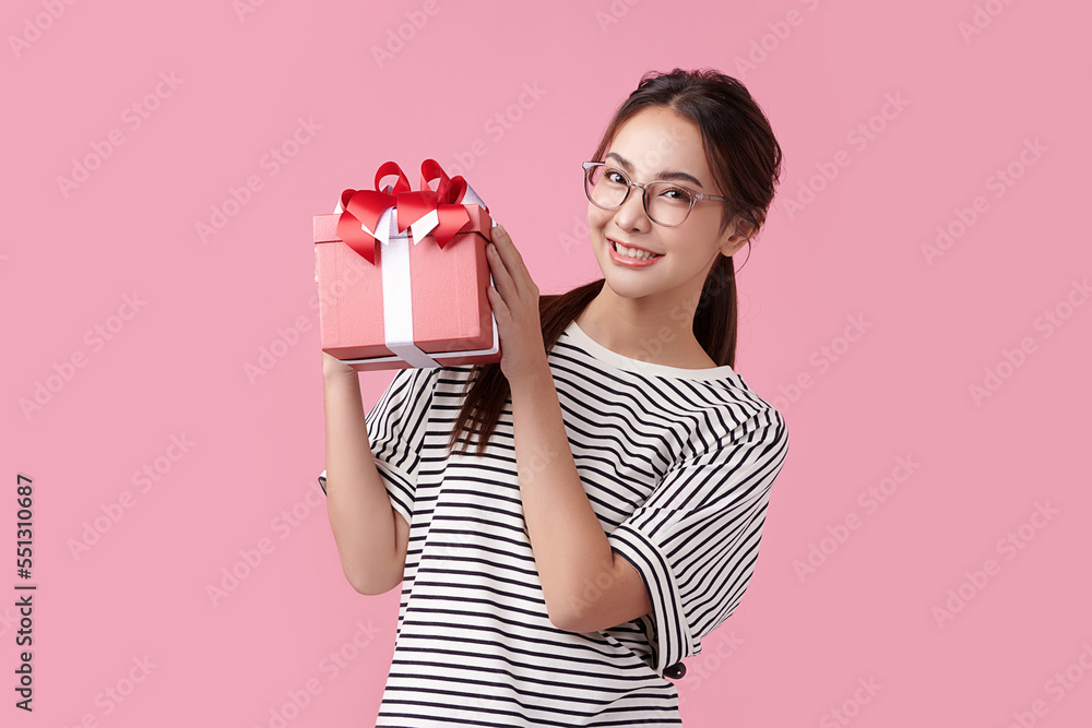 Cheerful teenagers happy with gift boxes on pink background Cheerful teenagers happy with gift boxes on pink background