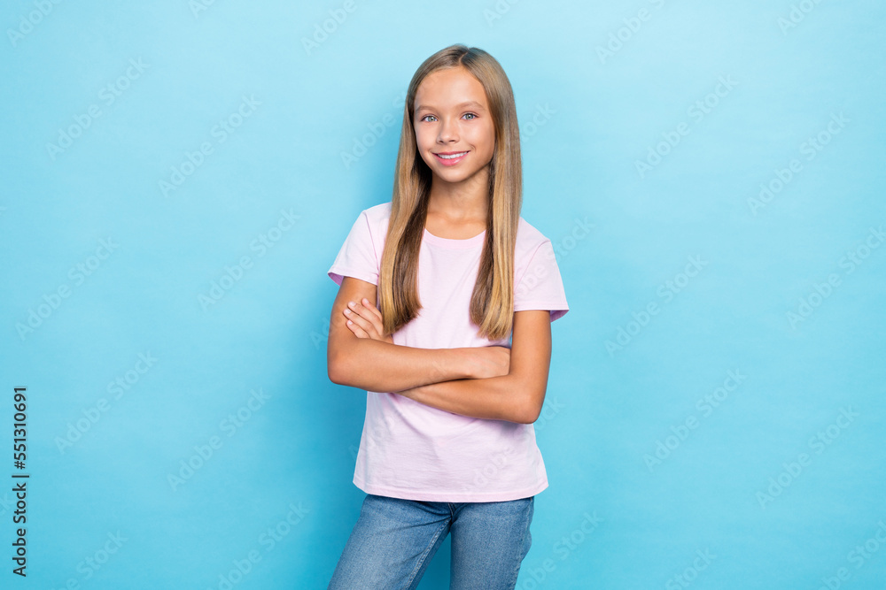 Photo of satisfied glad girl beaming smile crossed arms have good mood isolated on blue color background Photo of satisfied glad girl beaming smile crossed arms have good mood isolated on blue color background