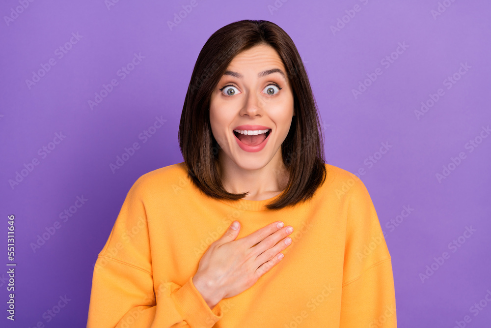 Fototapeta premium Photo of young adorable cute girlish lady wear orange sweater touch chest surprised open mouth unbelievable reaction isolated on purple color background