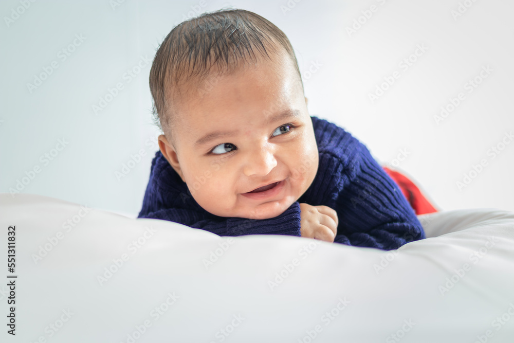 infant boy lying cute facial expression with white background at indoor infant boy lying cute facial expression with white background at indoor