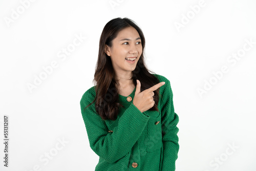 Young beautiful Asian businesswoman smiling and pointing to empty copy space isolated on white background. © Parichat