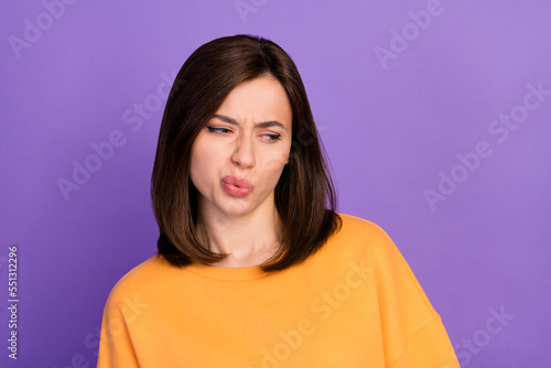 Closeup photo of young pretty gorgeous nice girlish lady wear orange sweater pouted lips unhappy look empty space unsatisfied isolated on violet color background