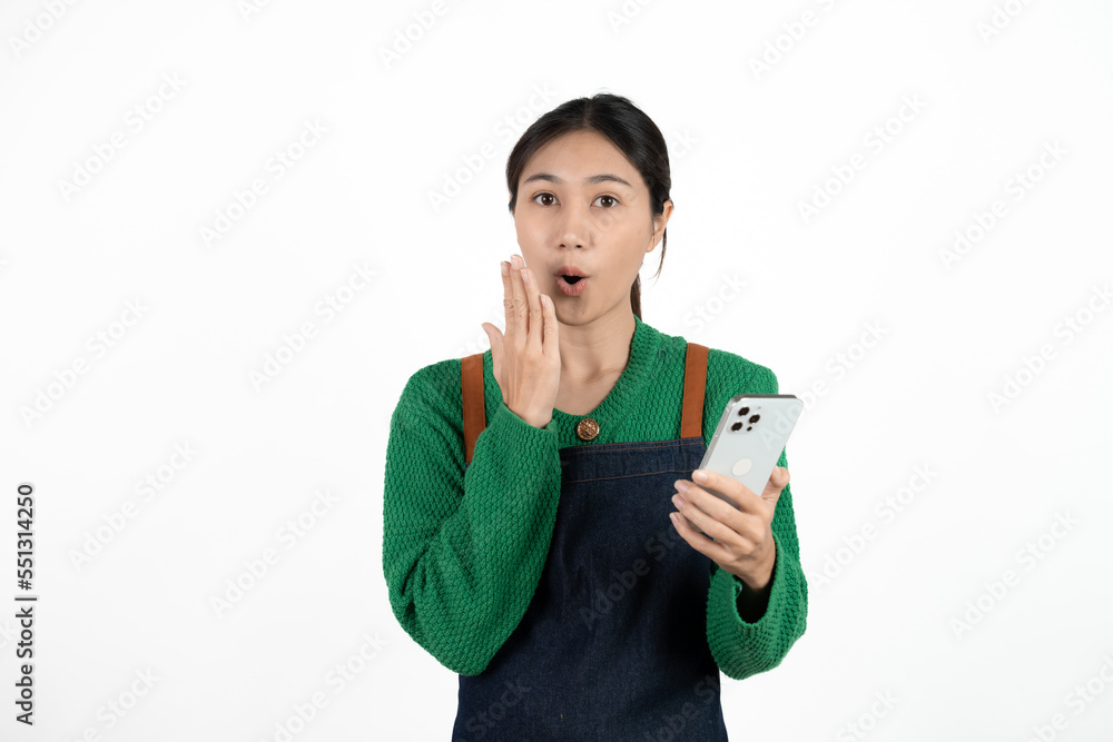 Asian waitress holding the phone with a surprised face isolated on white background. Asian waitress holding the phone with a surprised face isolated on white background.