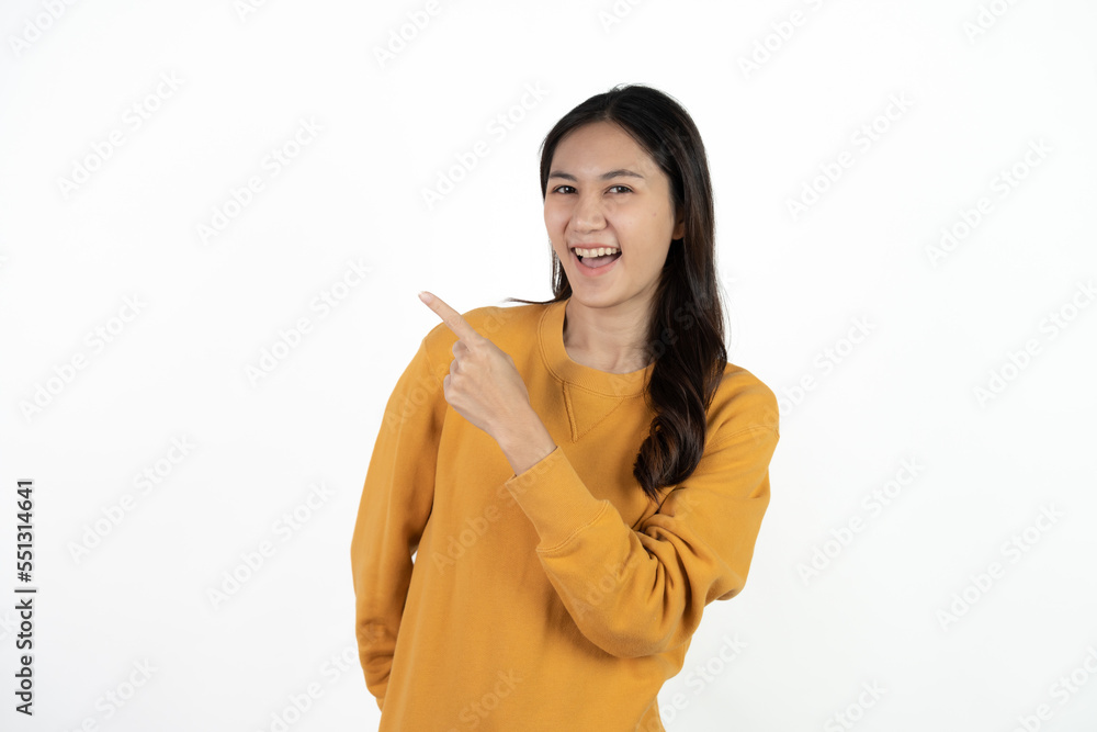 Young beautiful Asian businesswoman smiling and pointing to empty copy space isolated on white background. Young beautiful Asian businesswoman smiling and pointing to empty copy space isolated on white background.