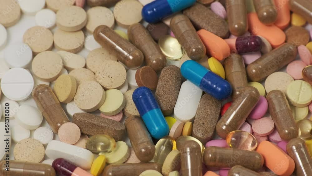 Background of different pills rotation. Drugs, pills, capsules, tablets, vitamins. Concept of pharmacy, medicine, healthcare, pharmaceutical industry. Rotating slow motion, top view. Various pills Background of different pills rotation. Drugs, pills, capsules, tablets, vitamins. Concept of pharmacy, medicine, healthcare, pharmaceutical industry. Rotating slow motion, top view. Various pills
