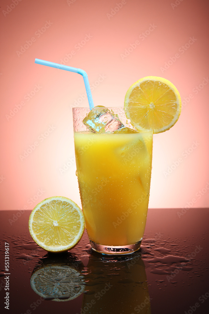 Fototapeta premium Fruit cocktail with ice cubes and lemon slices on a gradient background