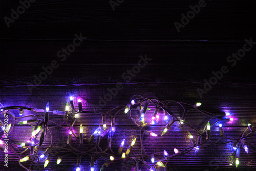 Christmas neon lights on dark wooden background
