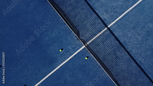 upward drone video footage on a blue paddle tennis court, sports courts