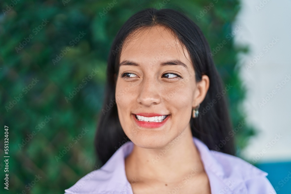 Young beautiful hispanic woman smiling confident looking to the side at park Young beautiful hispanic woman smiling confident looking to the side at park