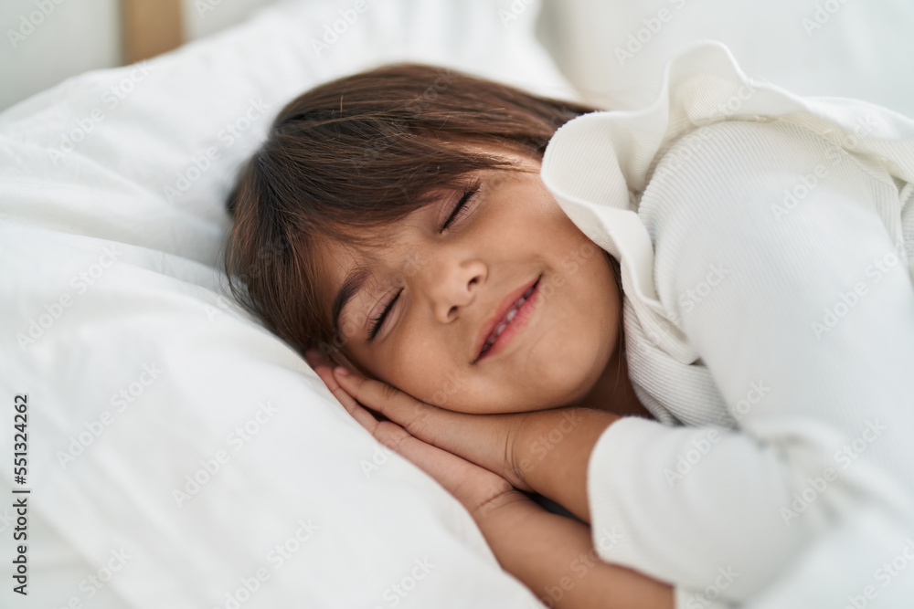 Adorable hispanic girl lying on bed sleeping at bedroom Adorable hispanic girl lying on bed sleeping at bedroom