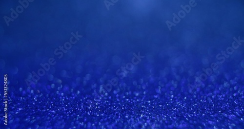 Bokeh light texture. Placement background. Sequin glare. Defocused blue color glowing round sparkles texture on abstract empty space wallpaper. © golubovy
