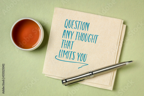 question any thought that limits you - inspirational advice written on a napkin with tea, mindset, growth and personal development concept