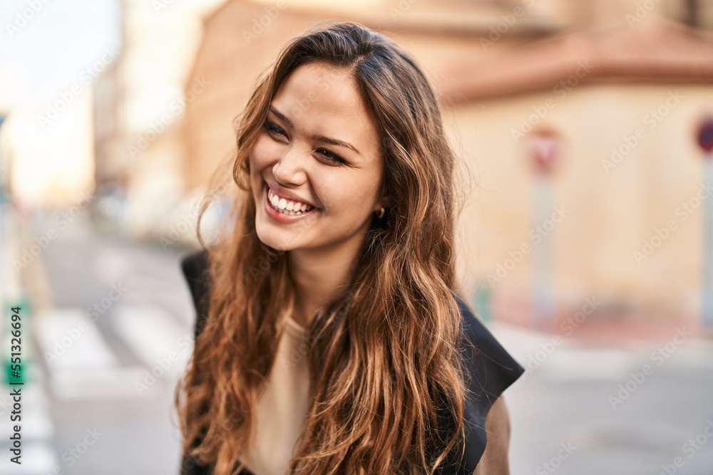 Young beautiful hispanic woman smiling confident looking to the side at street Young beautiful hispanic woman smiling confident looking to the side at street