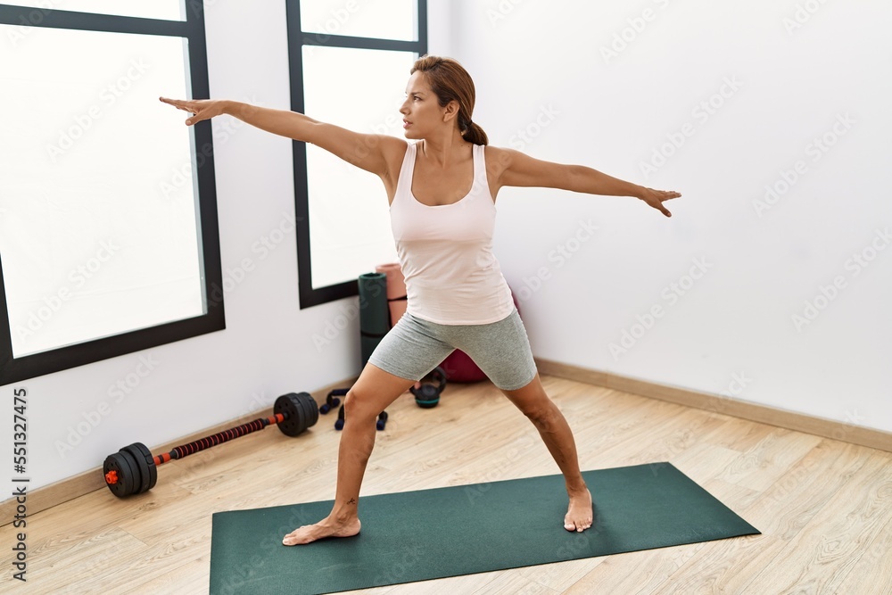 Young latin woman training yoga at sport center Young latin woman training yoga at sport center
