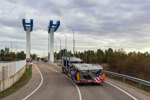 Empty car transporter truck crossing a drawbridge, Rear view.