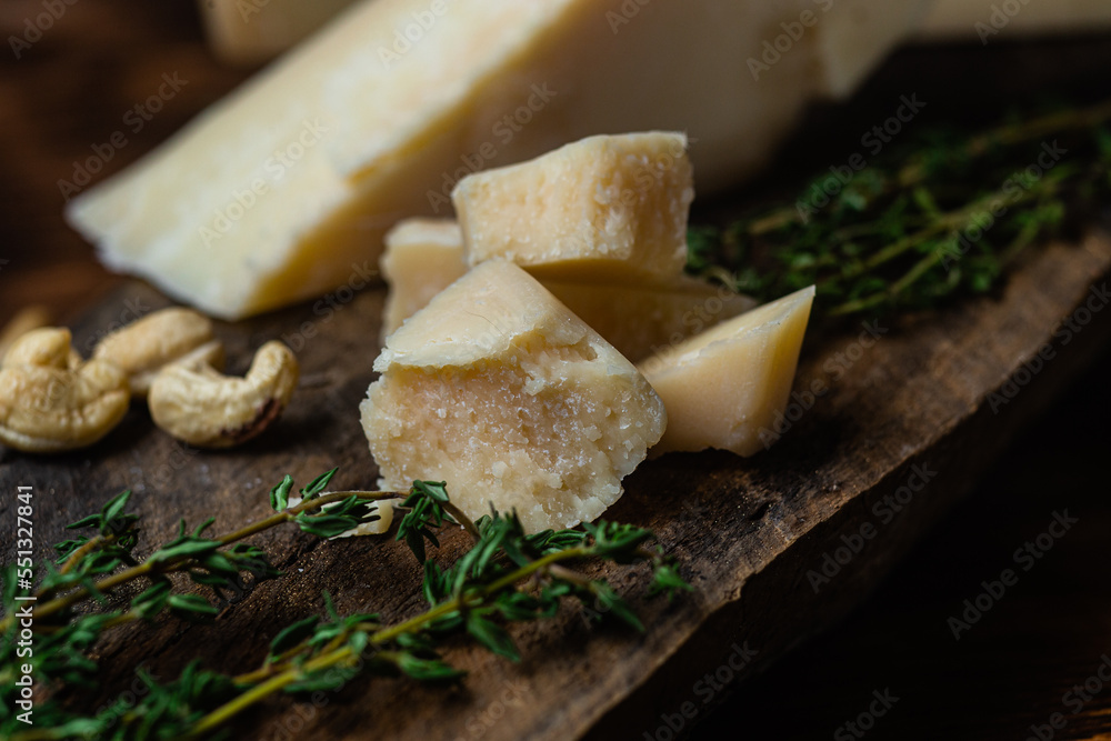 Parmesan cheese on a dark background close-up