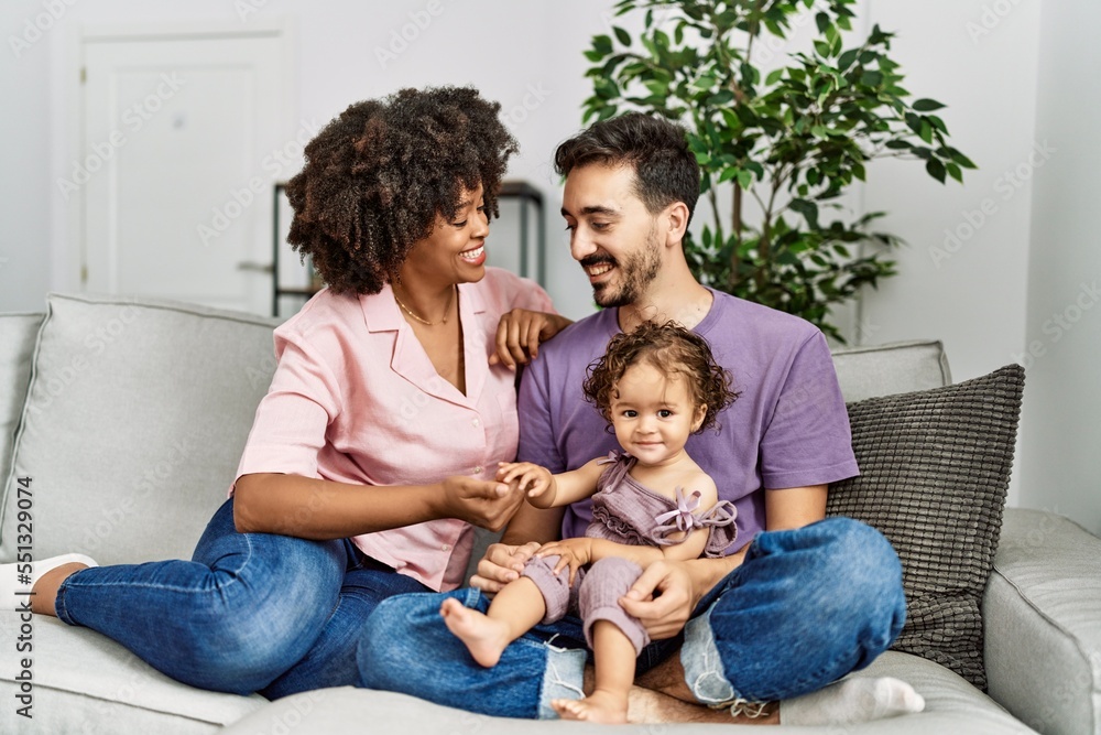 Couple and daughter smiling confident sitting on sofa at home Couple and daughter smiling confident sitting on sofa at home