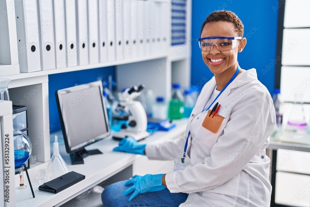 African american woman scientist smiling confident using computer at laboratory African american woman scientist smiling confident using computer at laboratory