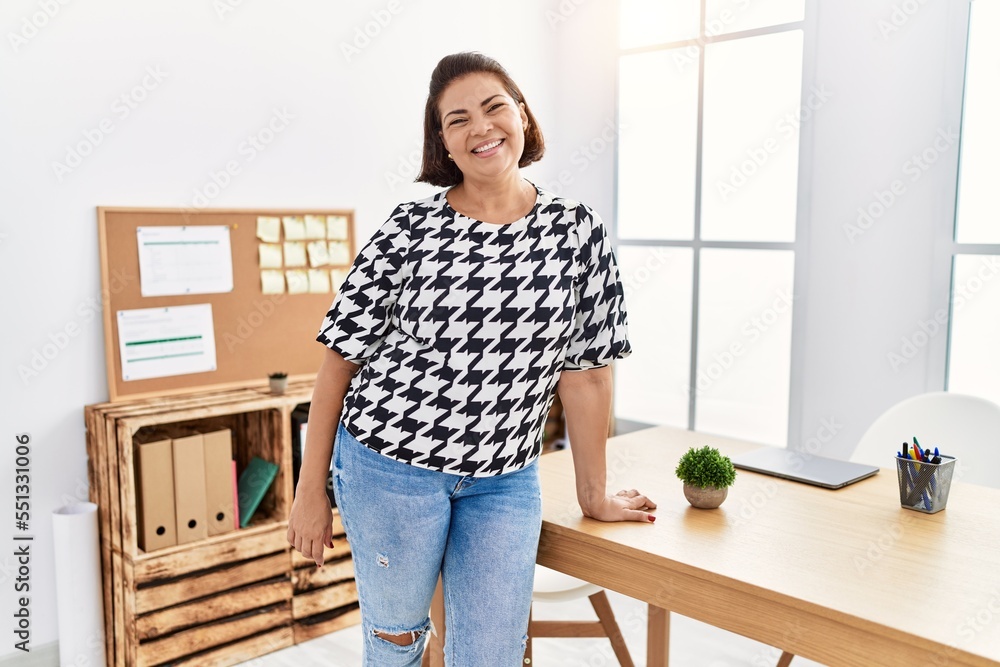 Middle age hispanic woman smiling confident working at office Middle age hispanic woman smiling confident working at office