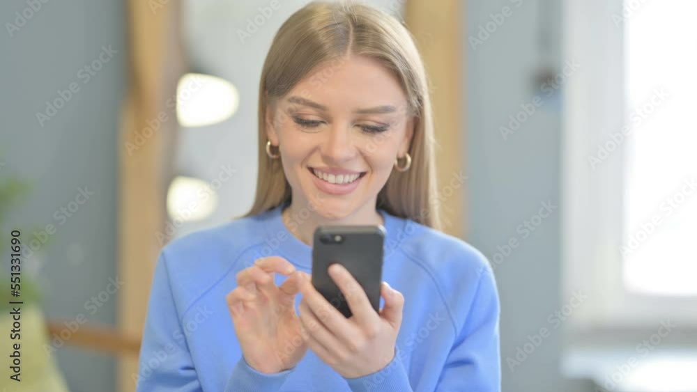 Excited Woman Celebrating Win on Smartphone Excited Woman Celebrating Win on Smartphone