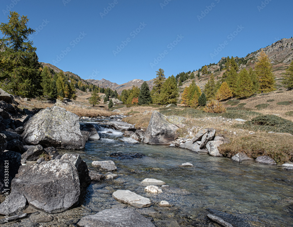 View of Claree river in Claree valley with Massif de Cerces mountains on either site, near Navache village and Briancon, Hautes-Alpes department, France View of Claree river in Claree valley with Massif de Cerces mountains on either site, near Navache village and Briancon, Hautes-Alpes department, France
