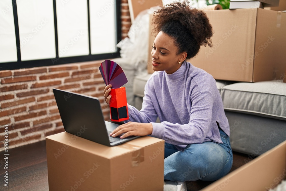 Young african american woman smiling confident choosing paint color at new home Young african american woman smiling confident choosing paint color at new home