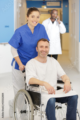 happy nurse talking care of a happy patient in wheelchair